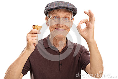 elderly-man-eating-cookie-making-ok-sign-isolated-white-background-77347975.jpg