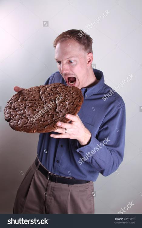 stock-photo-hungry-man-eating-a-giant-cookie-68015212.jpg